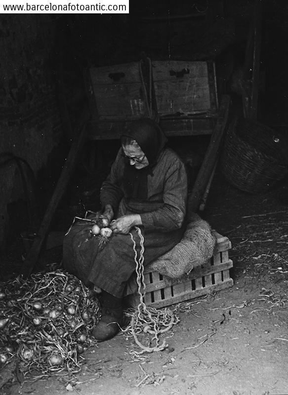 Old woman tying onions
